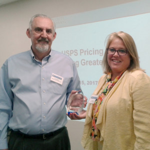 AMG's President, Csaba Mathe, receiving the Mailing Innovation and Digital Award from The USPS' Vice President of Pricing and Costing, Sharon Owens